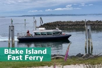 Blake Island Fast Ferry boat arriving to Blake Island with flowers and grass in foreground